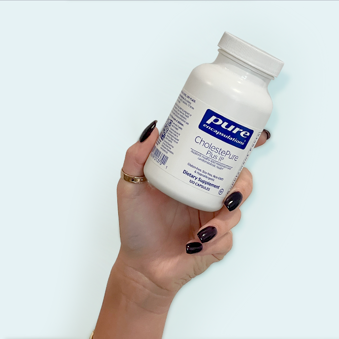 Hand Holding Pure Encapsulations Product
